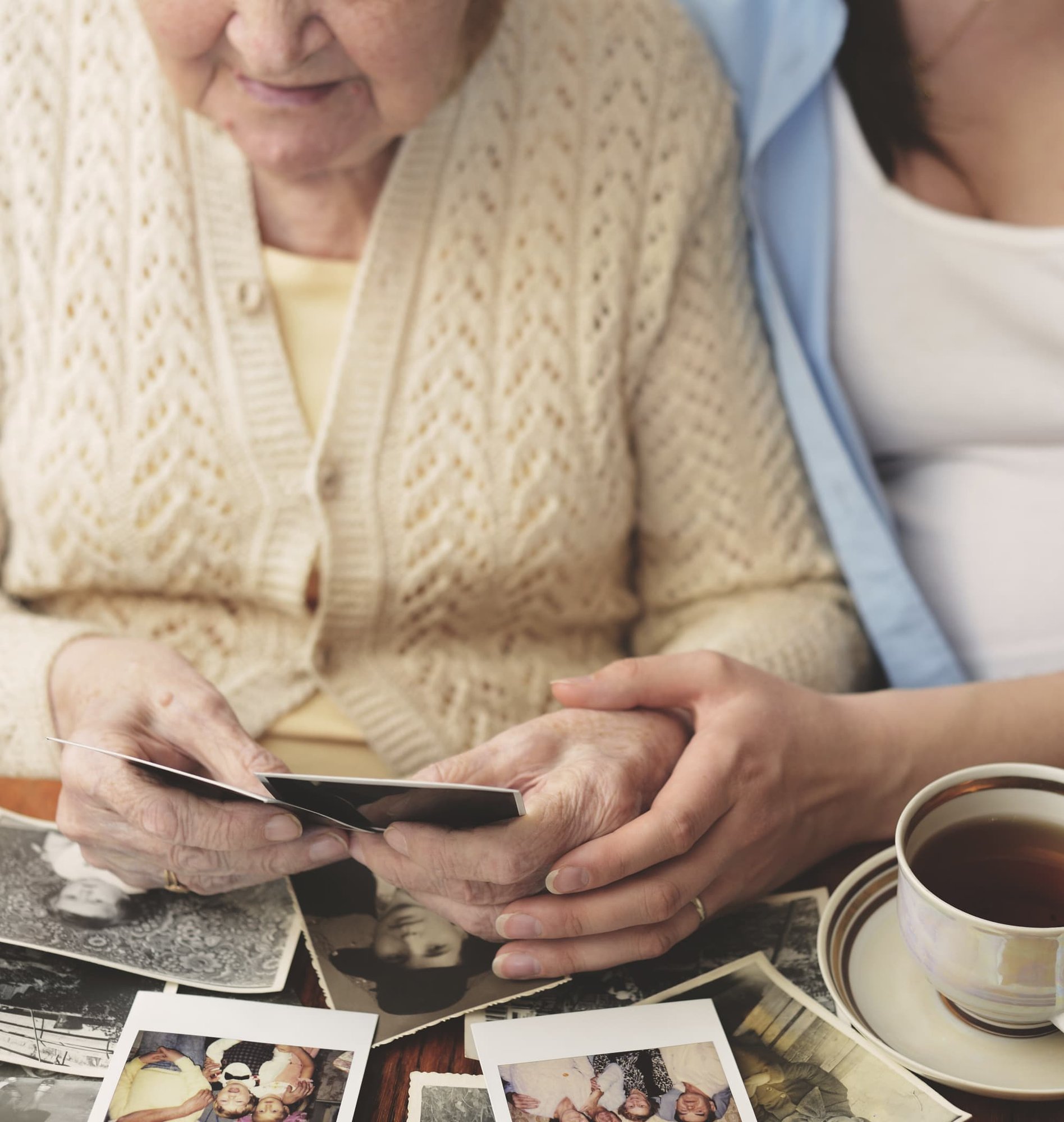 senior-woman-and-granddaughter-sitting-at-table-l-2024-06-13-16-58-11-utc (1)