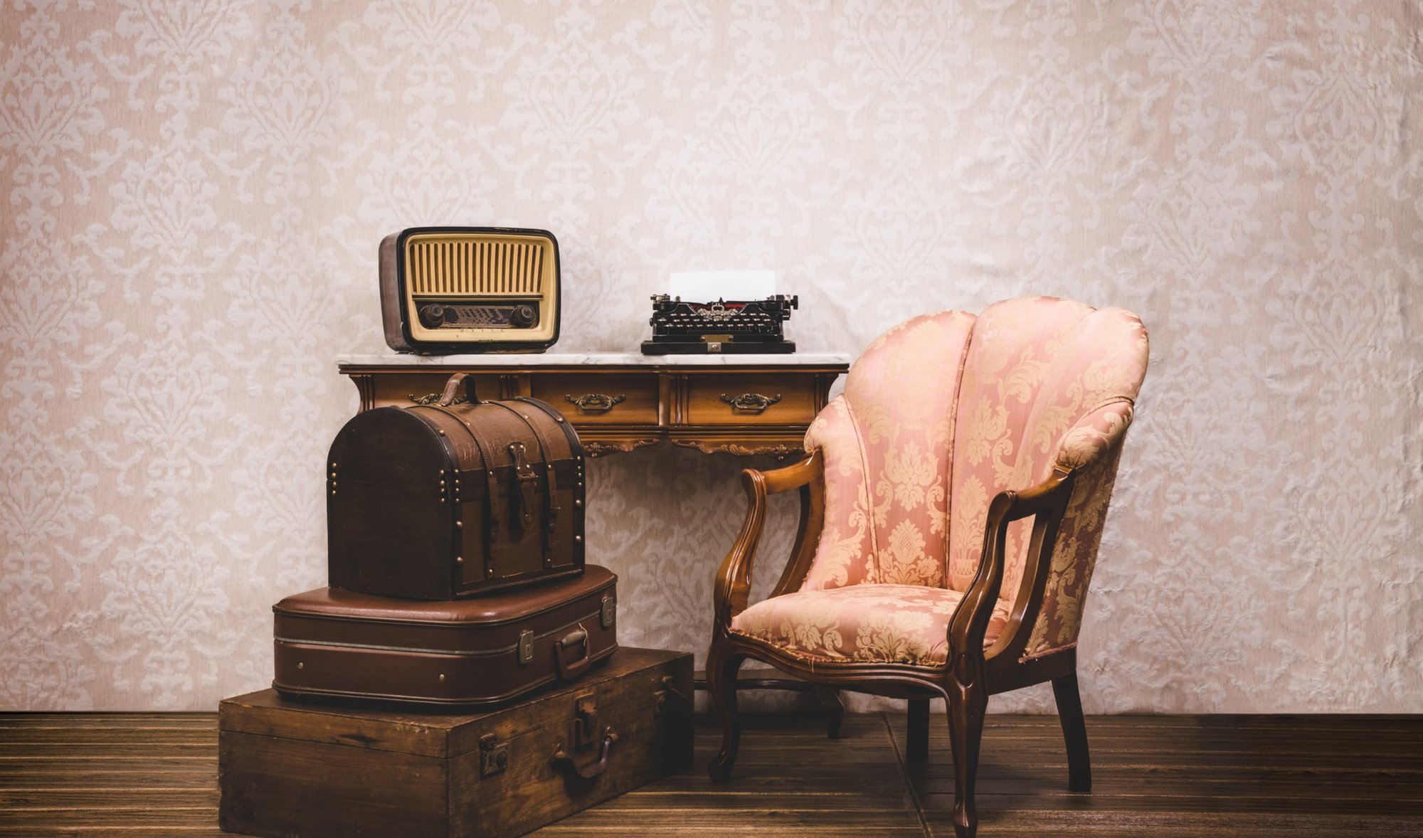 set-of-old-vintage-suitcases-typewriter-armchair-2023-11-27-05-30-32-utc